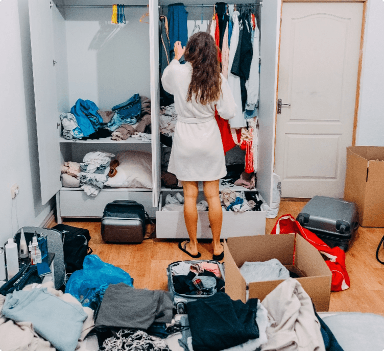 Woman in her cluttered wardrobe