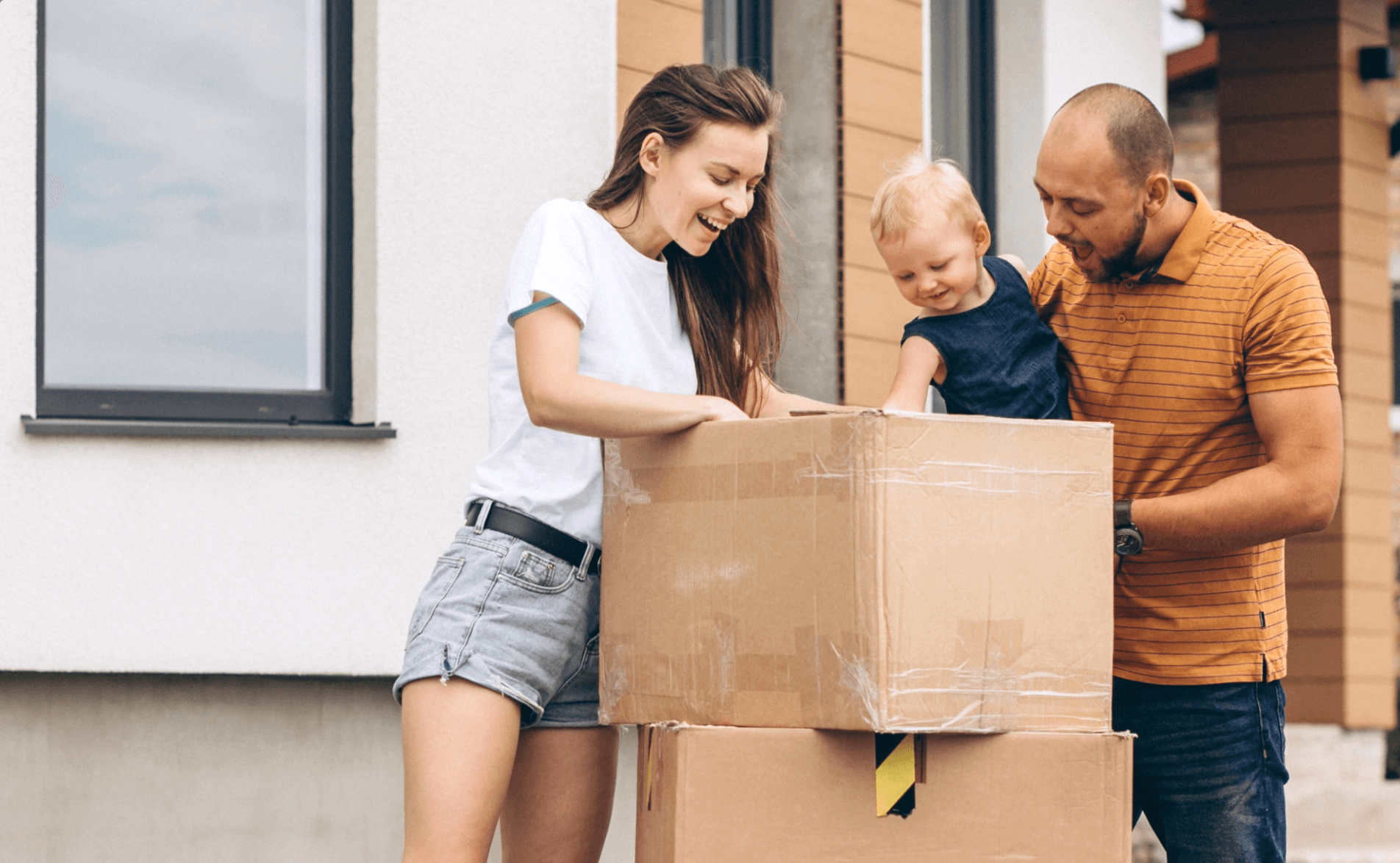 Young family with little daughter moving into new house